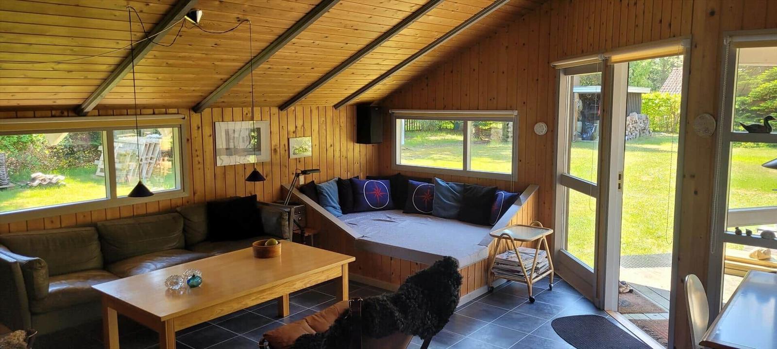 Apartment with kitchen, bathroom, two bedrooms, and living area. Compass orientation included.