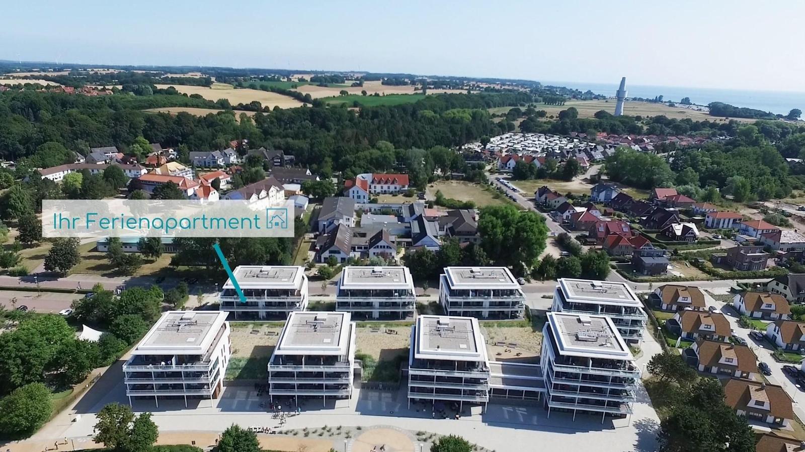 Ferienapartment in modernem Gebäudekomplex mit Blick auf Wald und Strand.