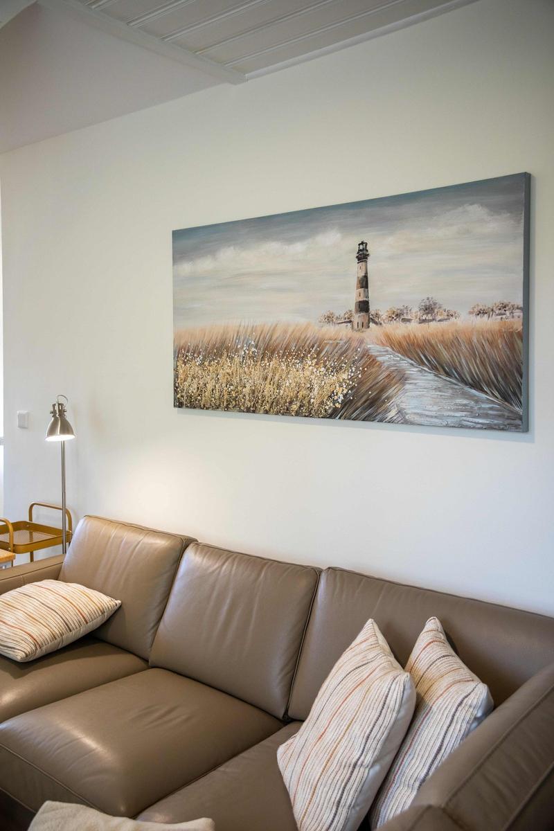 Wohnzimmer mit Sofa, TV und Blick in die Küche