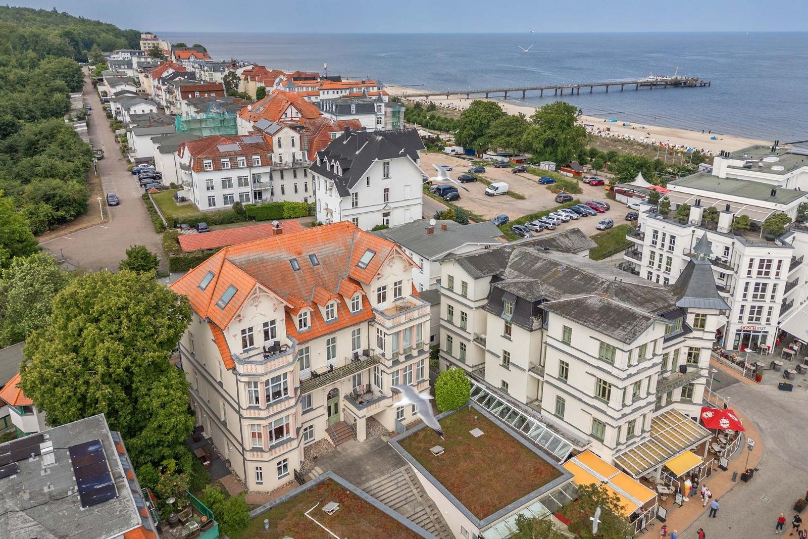 Historisches Gebäude mit rotem Dach und mehreren Balkonen.