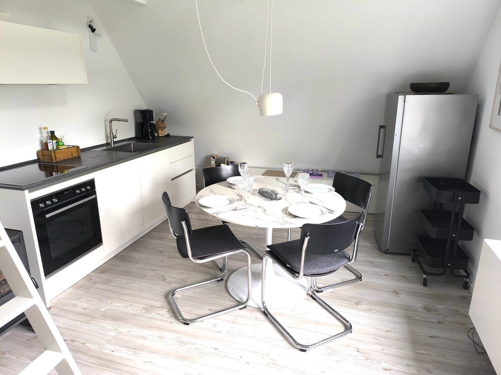 Ground floor with living area, veranda, and stairs to upper level.