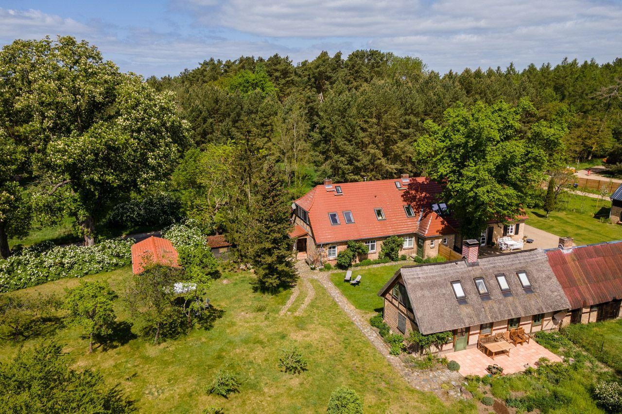 Aerial view of vacation home with fields and lake