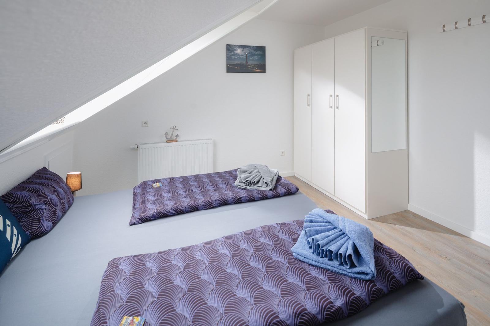 Badezimmer mit Waschbecken, Spiegel und Heizkörper an der Wand.