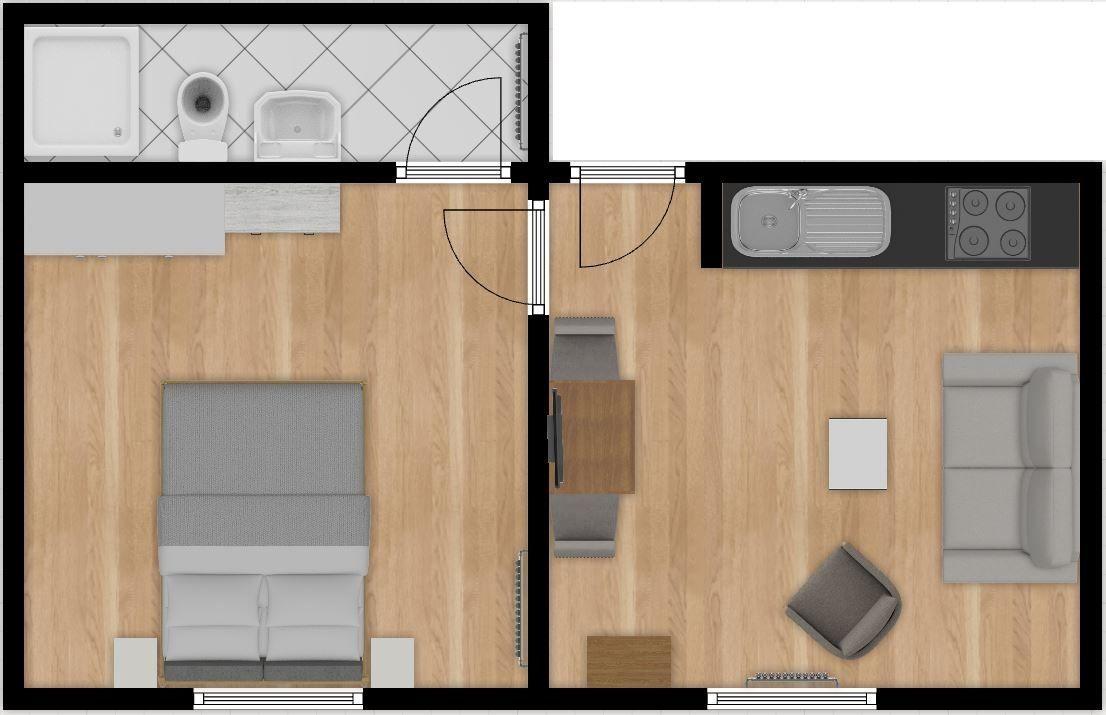 Küche mit weißen Schränken und dunklem Sofa mit Kissen und Tulpen.