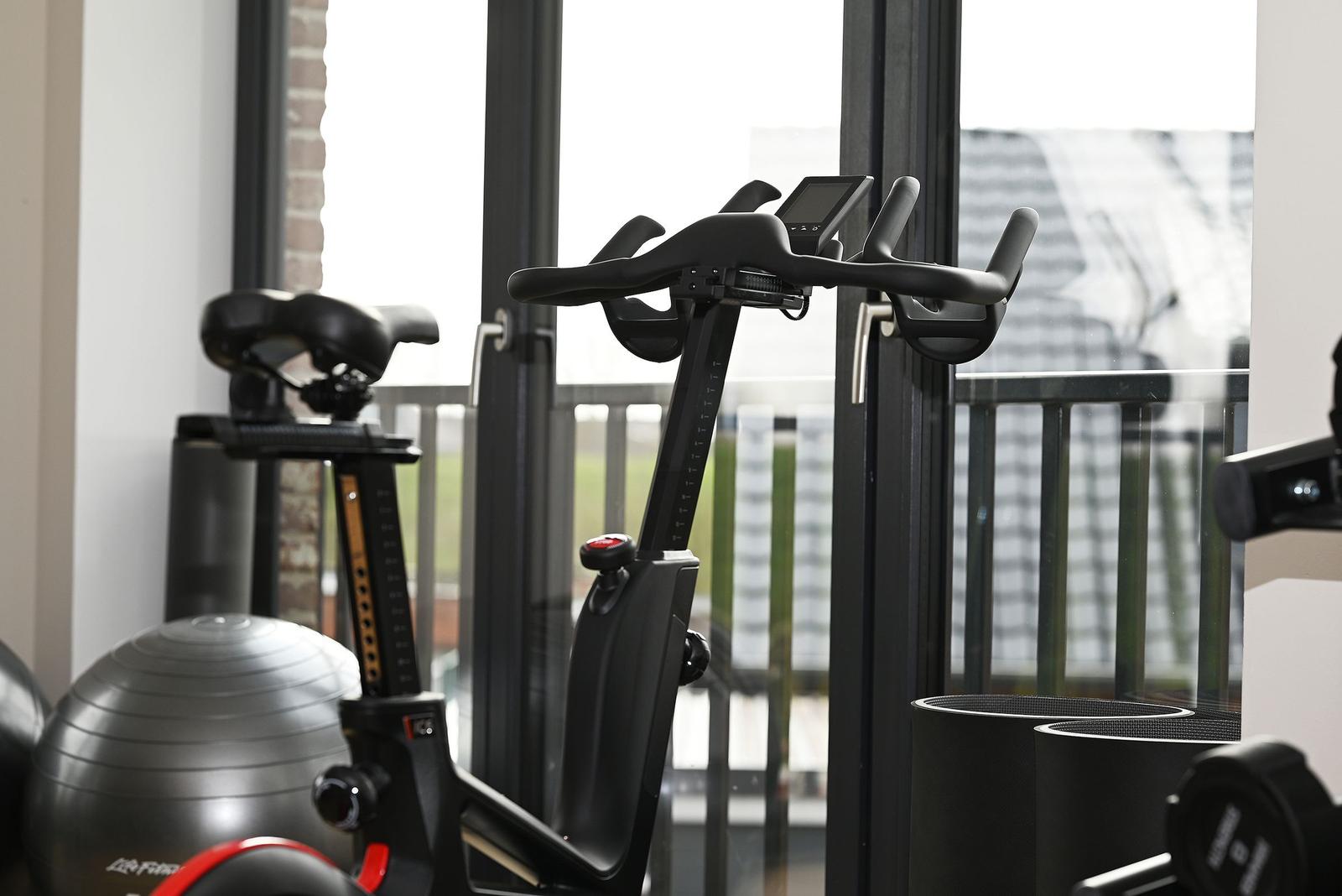 Room with chaise, table, and view of balcony with chair