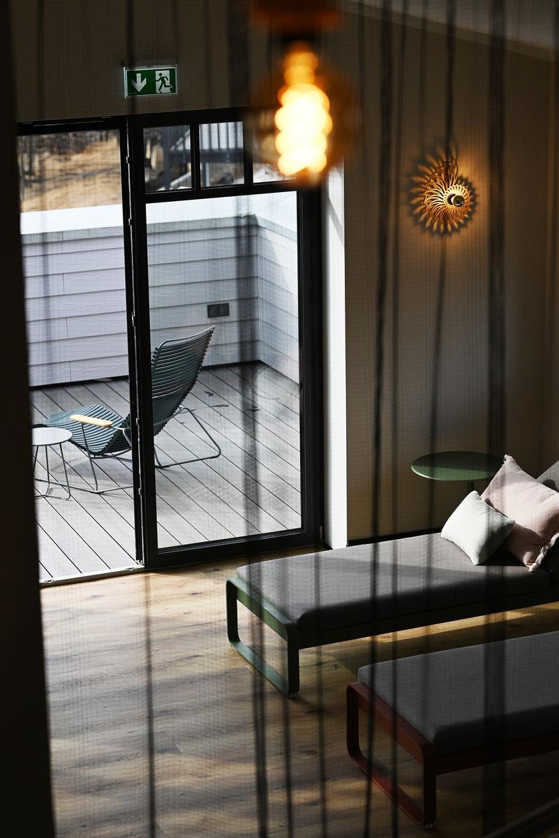 Finnish sauna with wooden door and glass panel inscription.