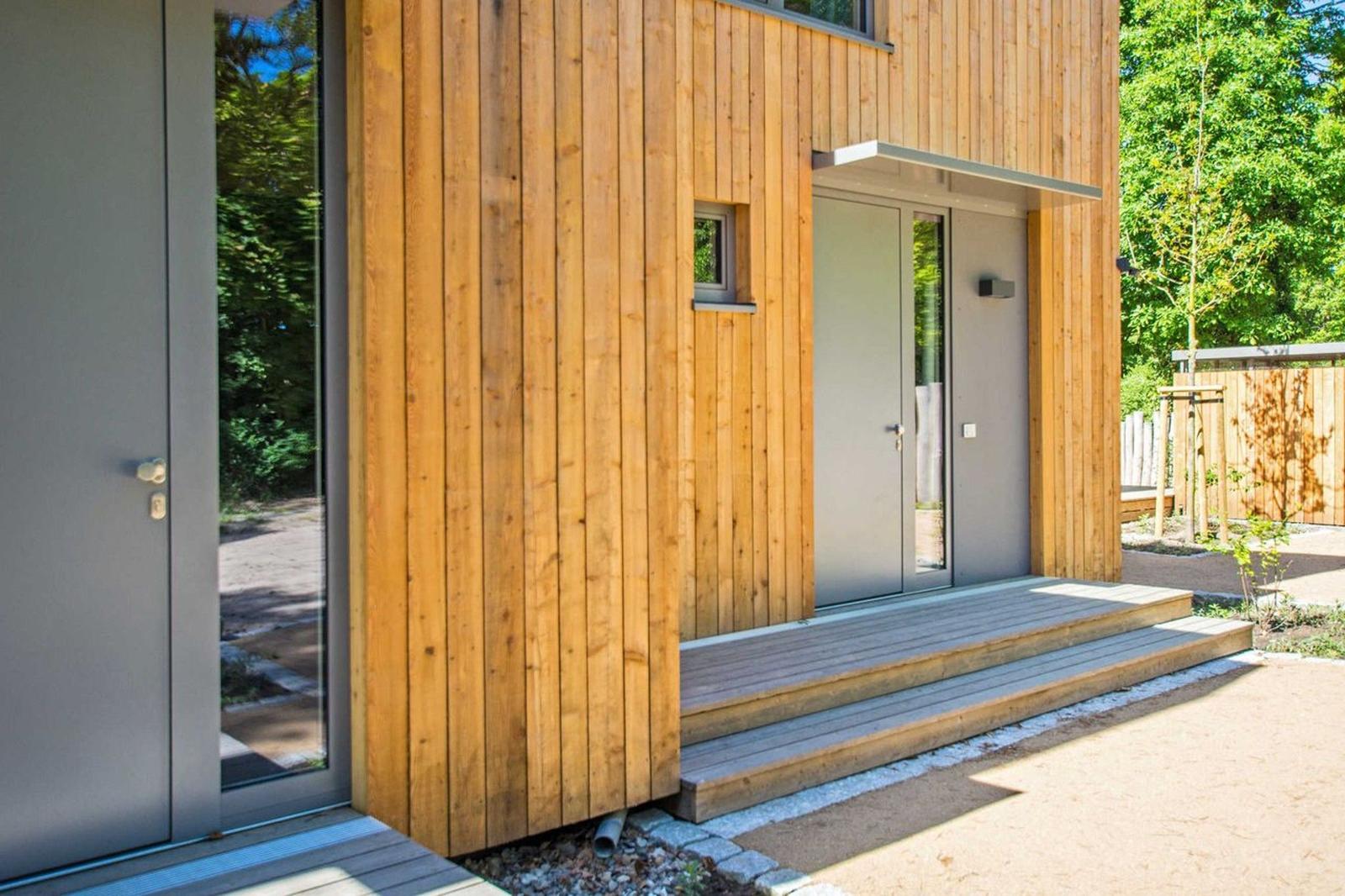 Moderne Holzhäuser mit Terrasse und Garten im Wald