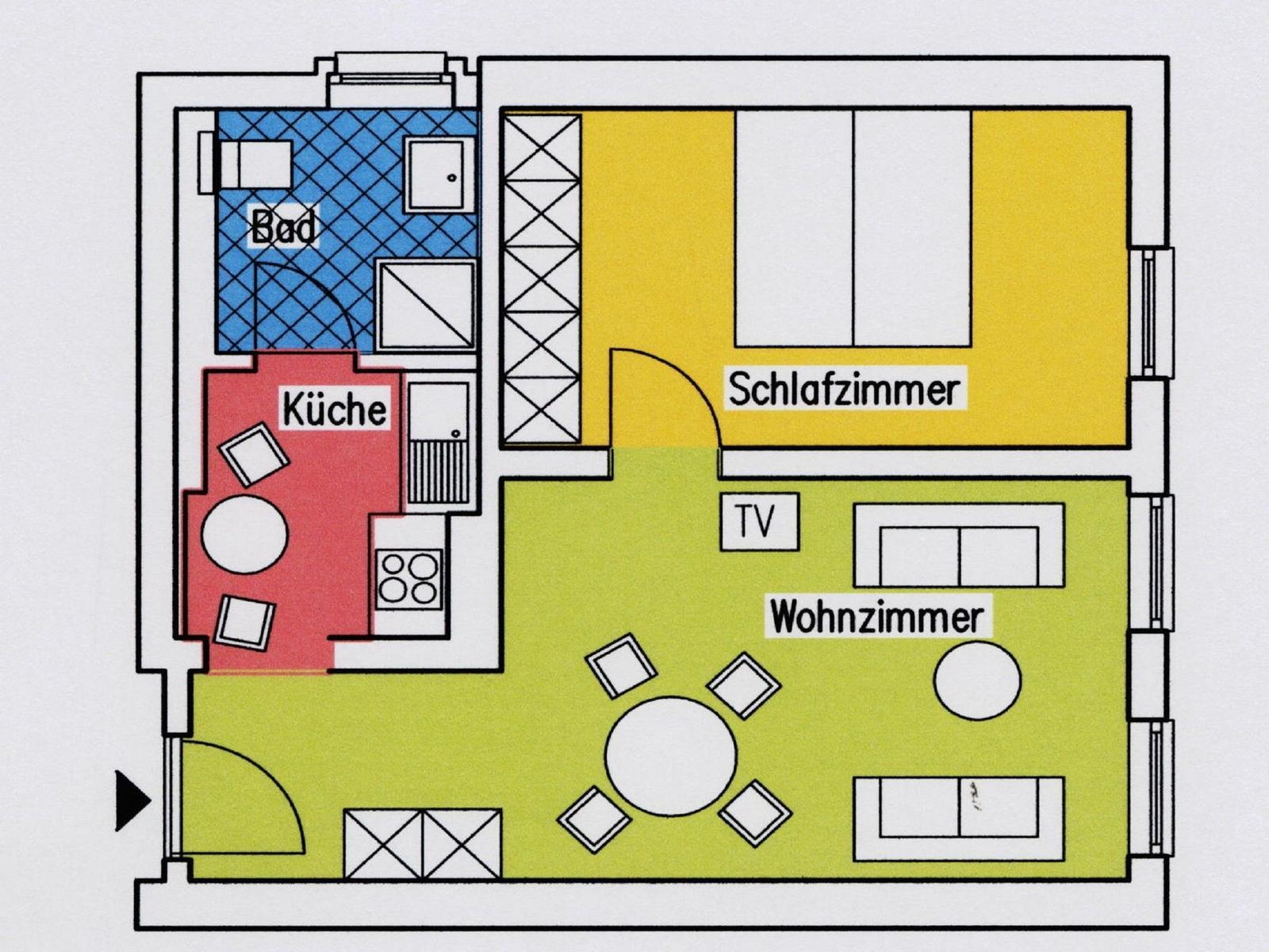 Weißes Mehrfamilienhaus mit Balkonen und Bäumen im Vordergrund.