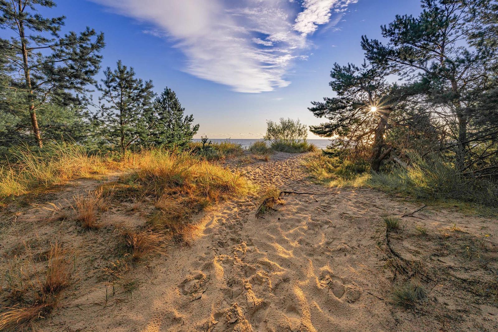 Wooden boat with cabin on the beach at sunset