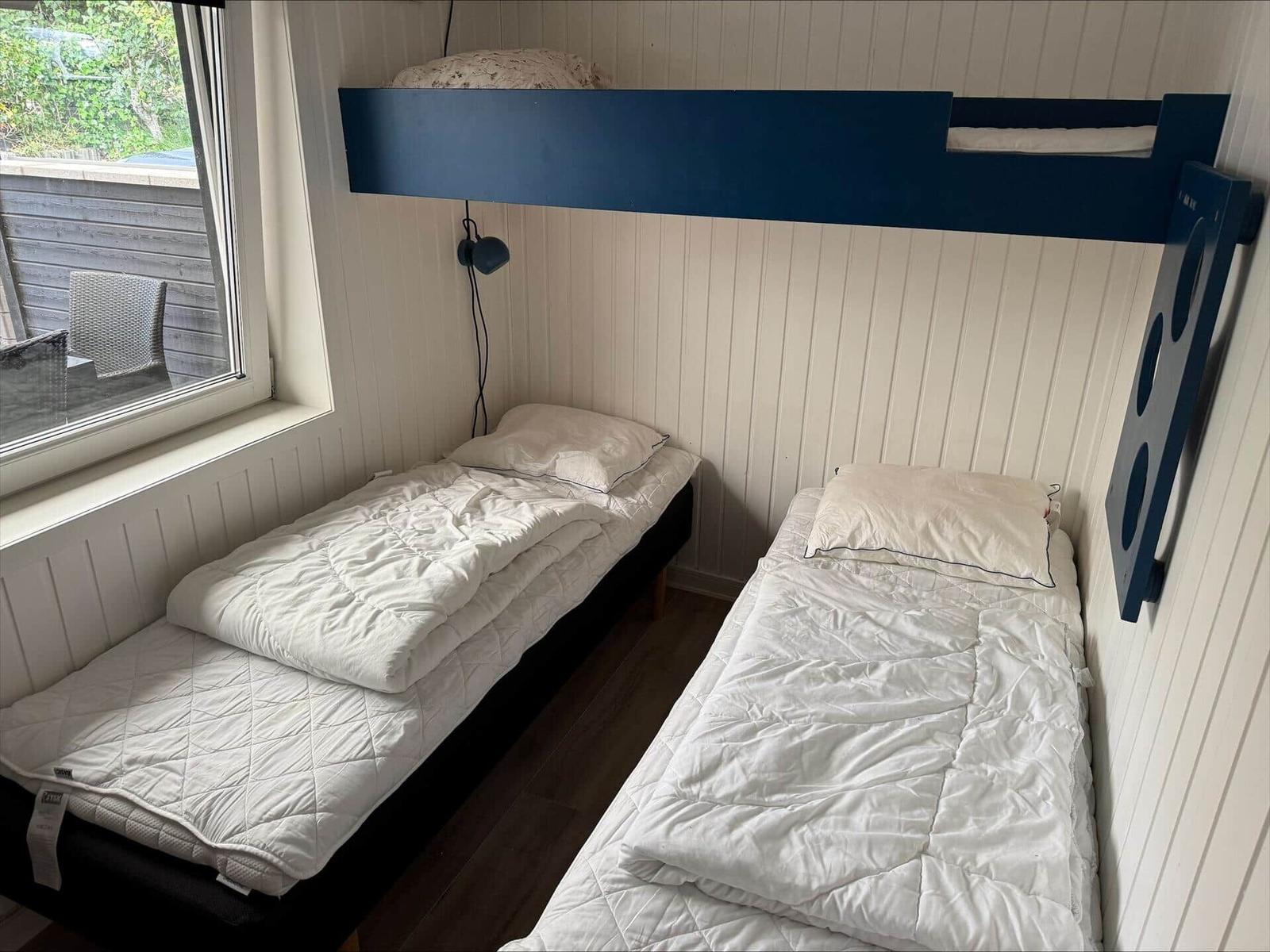 Apartment with three bedrooms, kitchen, and bathroom. Hall and living area marked.