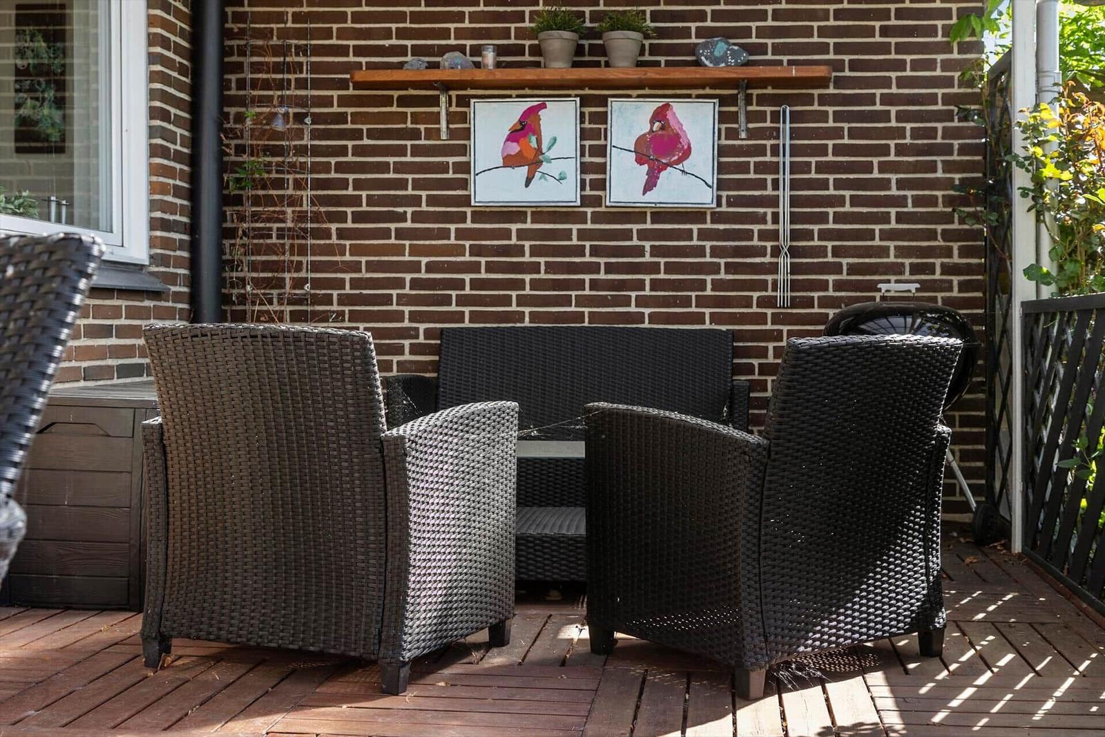 Terrace with table and chairs under a canopy.