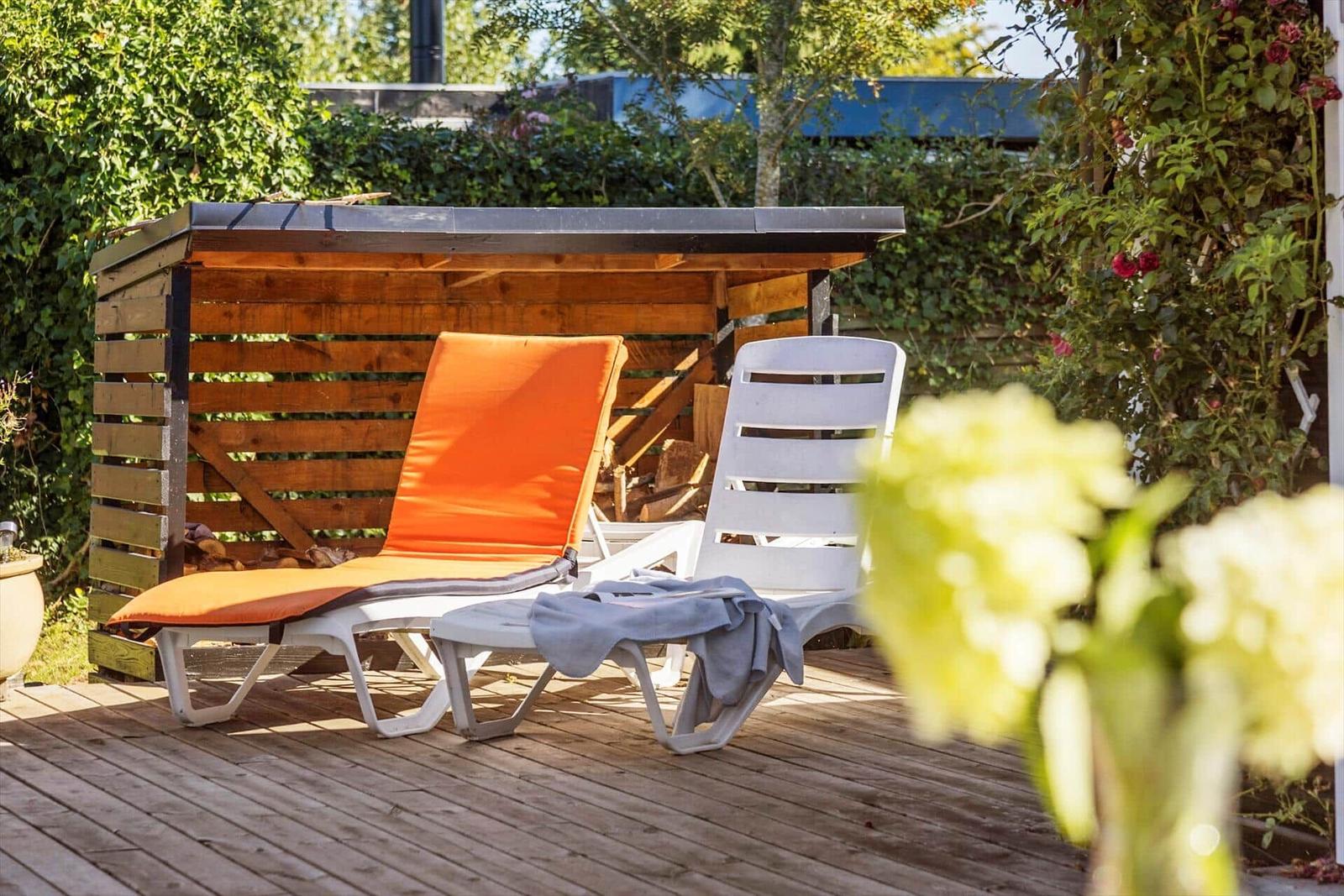 Wohn- und Essbereich mit Holzdecke, Sofa, Tisch und Stühlen.