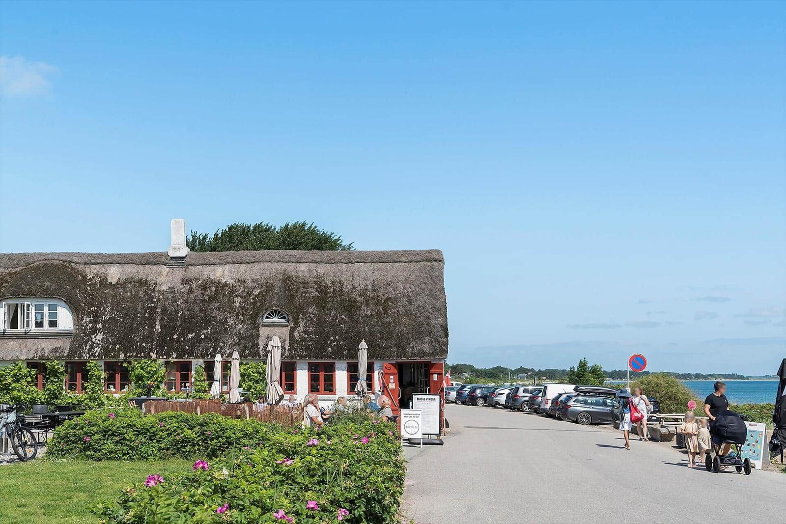 Haus mit Parkplatz und Blick auf Meer und Insel.
