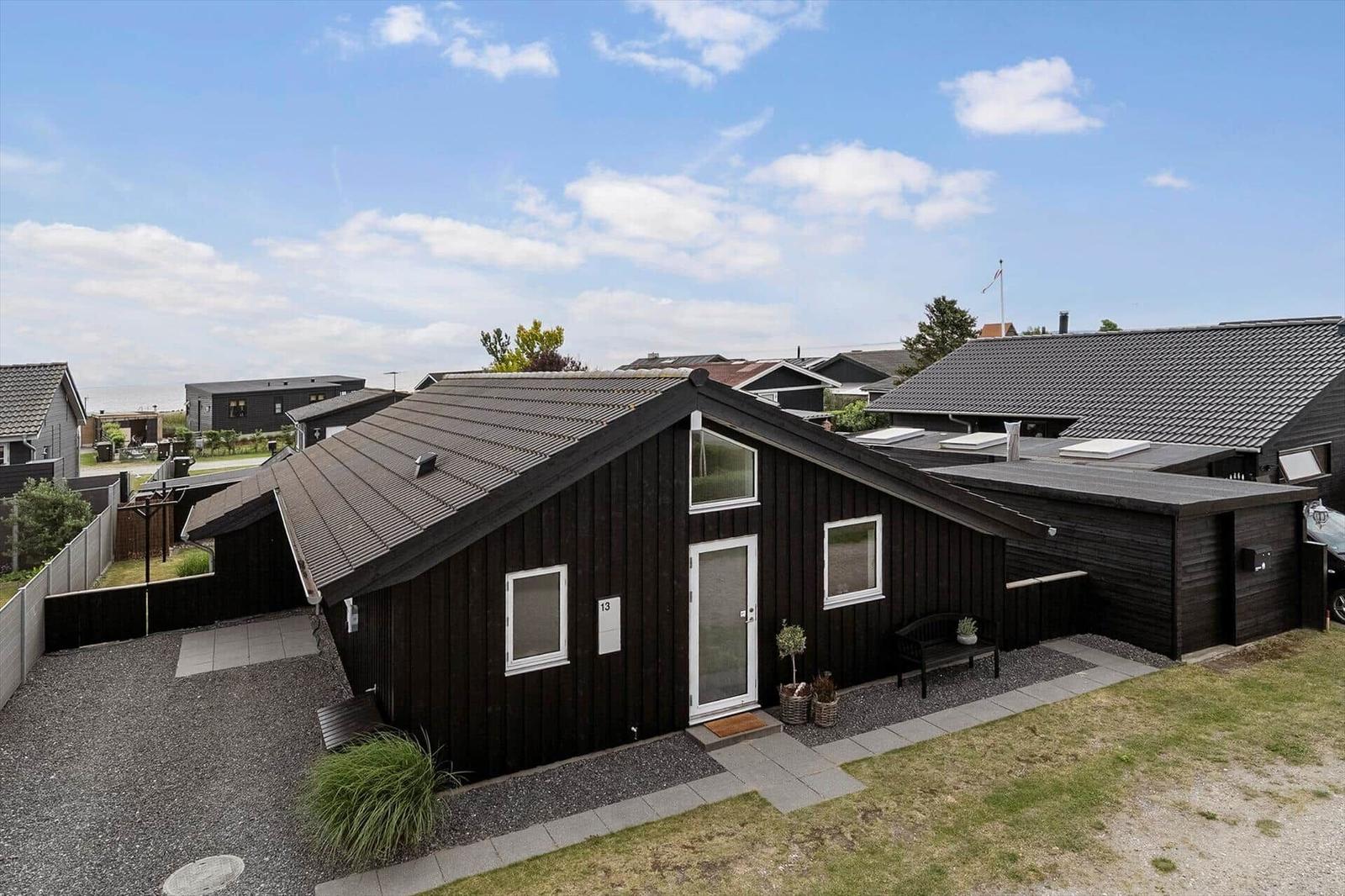 Modernes Ferienhaus mit Terrasse, Essbereich und Blick ins Innere.