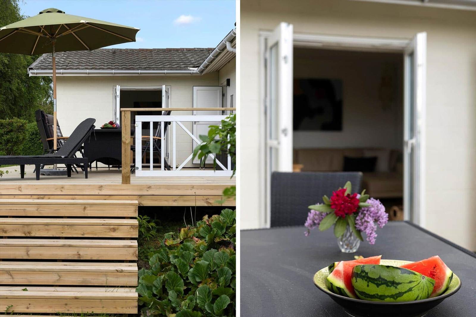 Terrace with table, chairs, umbrella, grill, and fire pit.