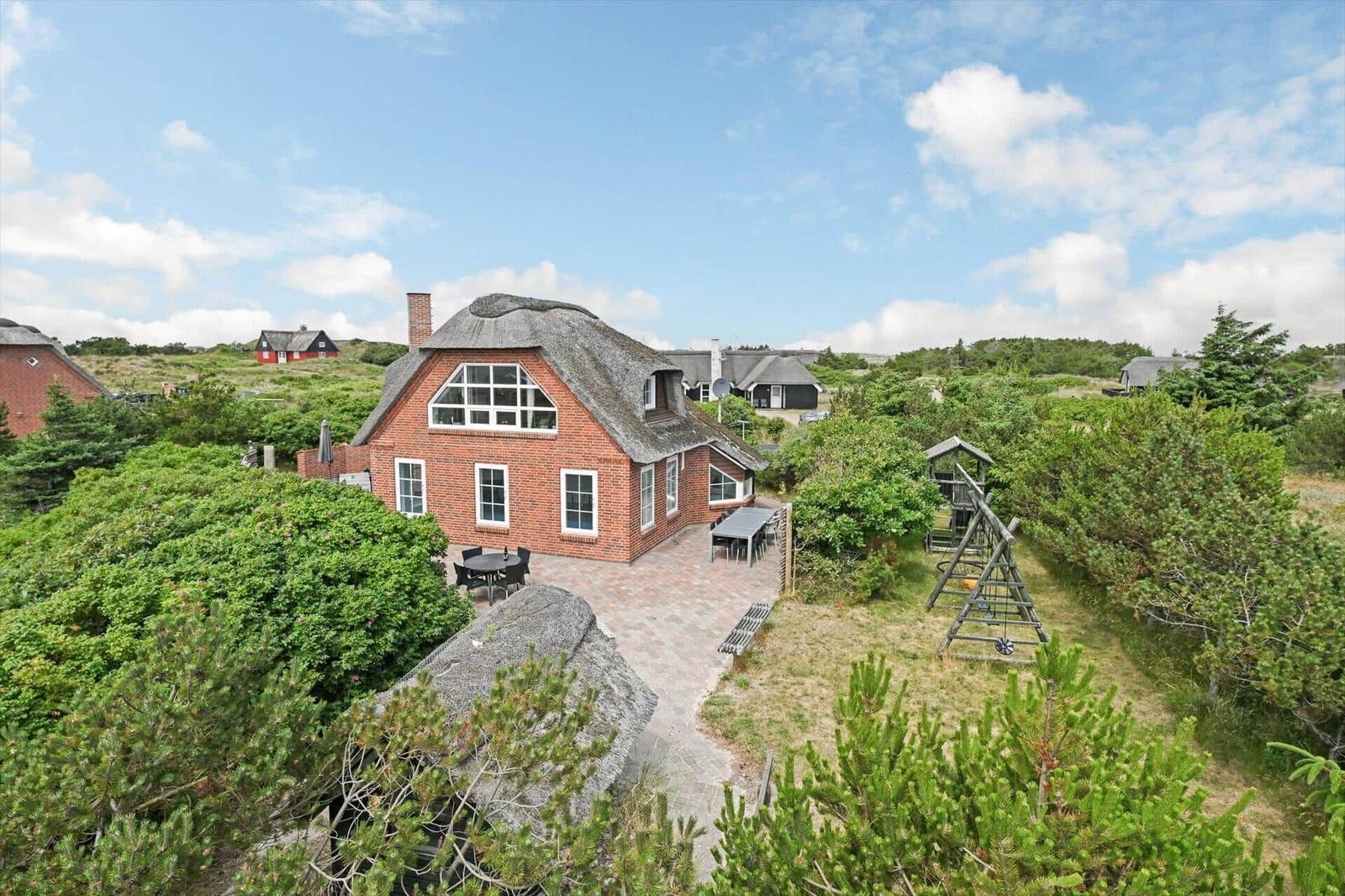 Ground floor plan with three bedrooms, bathroom, and staircase to upper level.