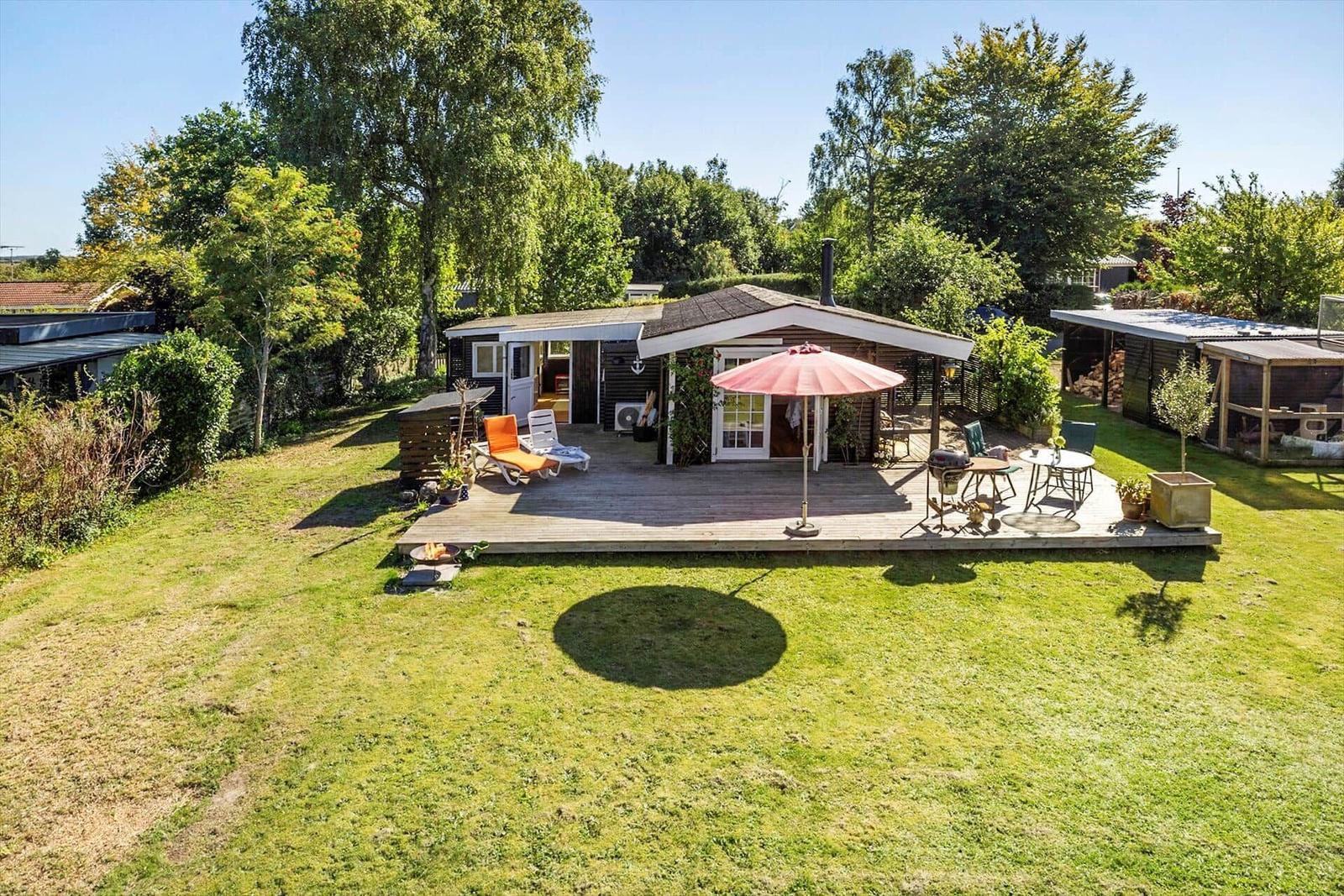 Deck with table and chairs, access to house via French doors.