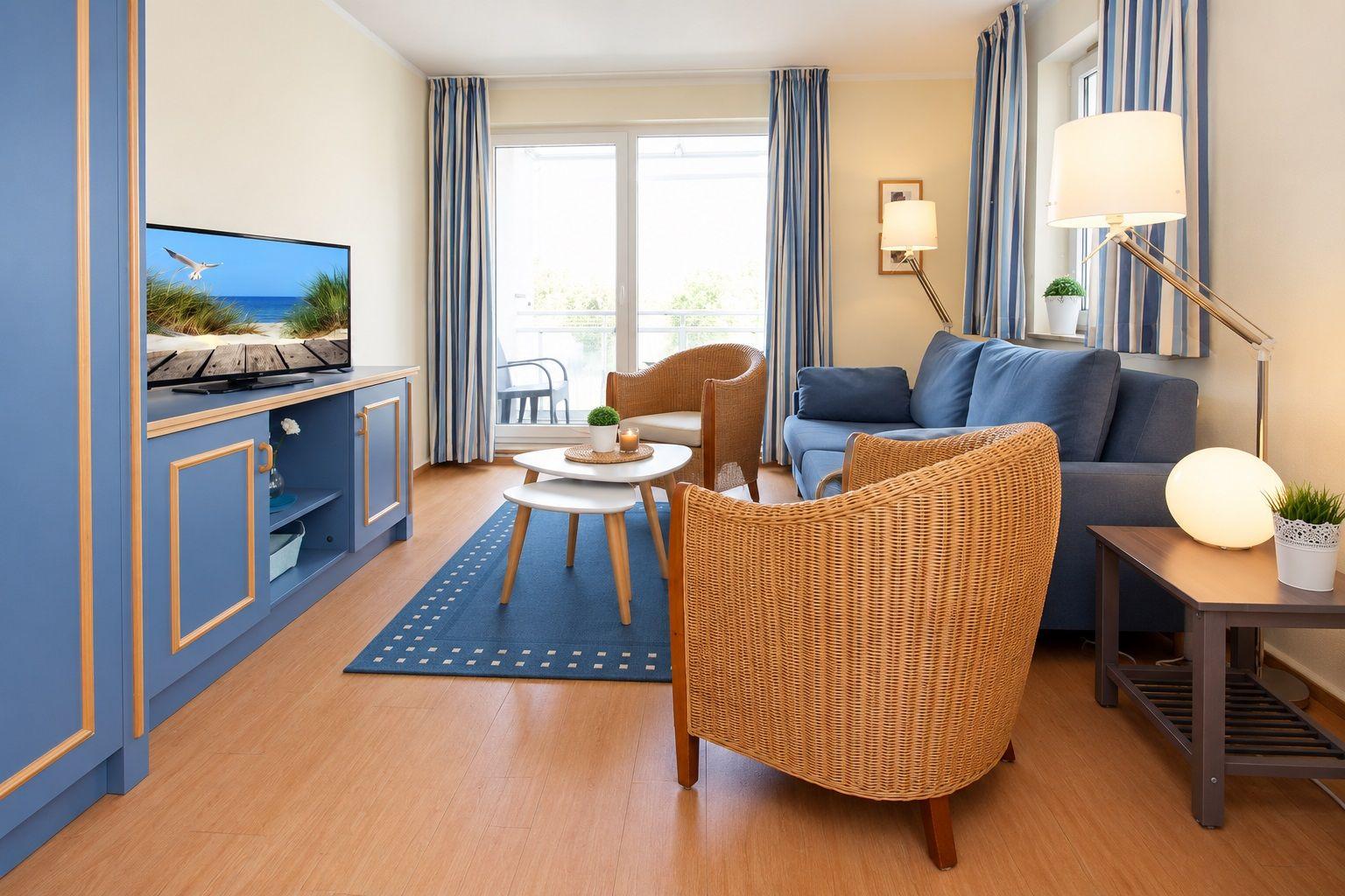Living room with sofa, chairs, and TV. Balcony with sea view.