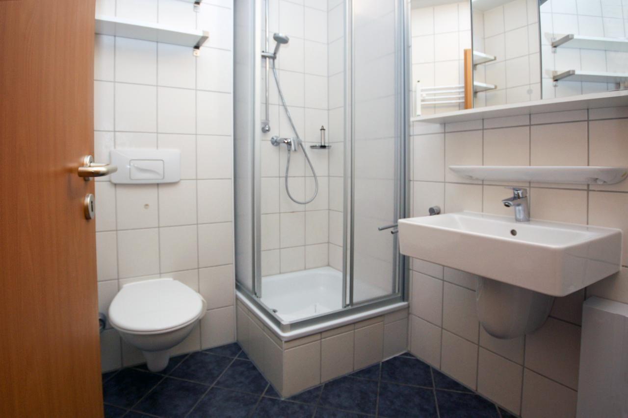 Bathroom with shower, sink and toilet.