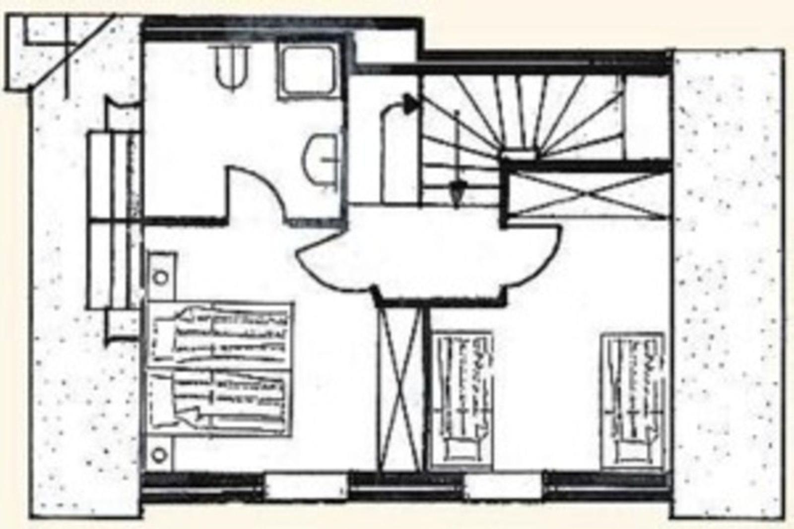 Ground floor with bedroom, bathroom, and stairs to upper level.