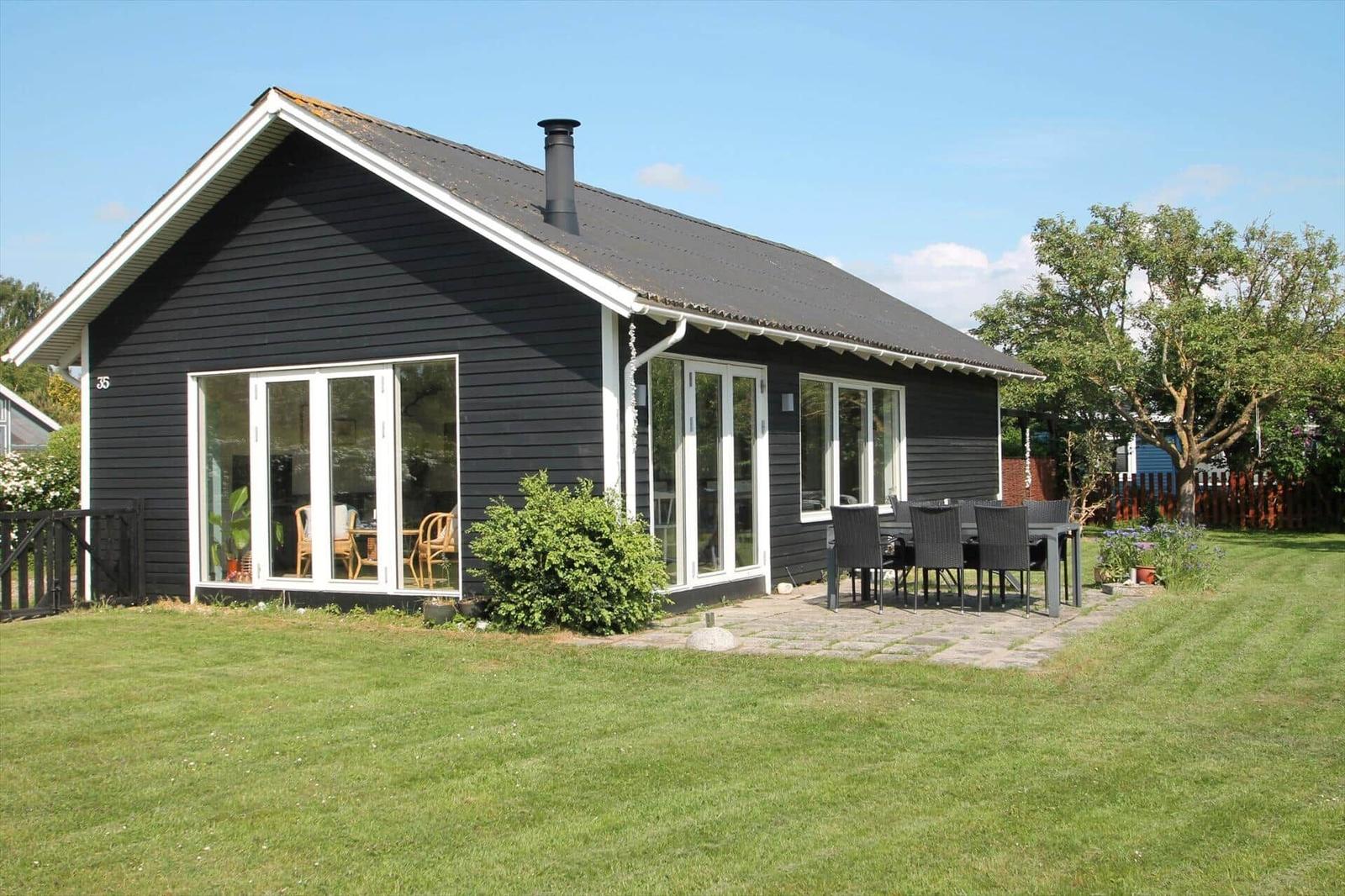 Apartment with three bedrooms, kitchen, bathroom, and covered terrace.