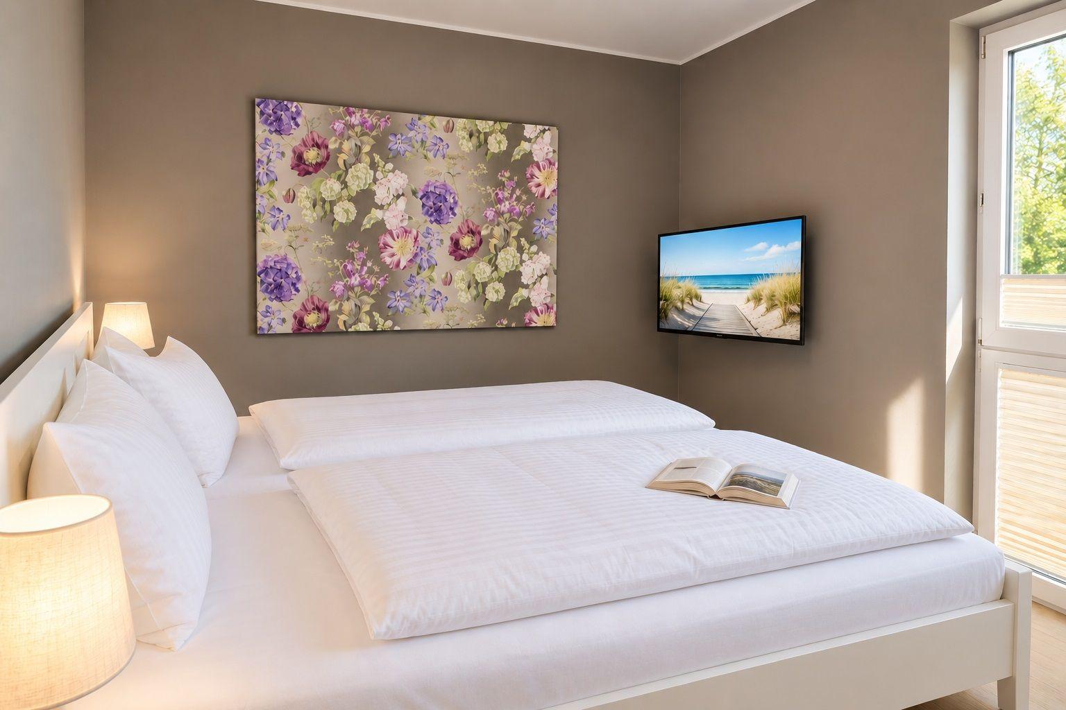 Essbereich mit Tisch und drei Stühlen, Wanduhr und Fernseher auf weißen Möbeln.