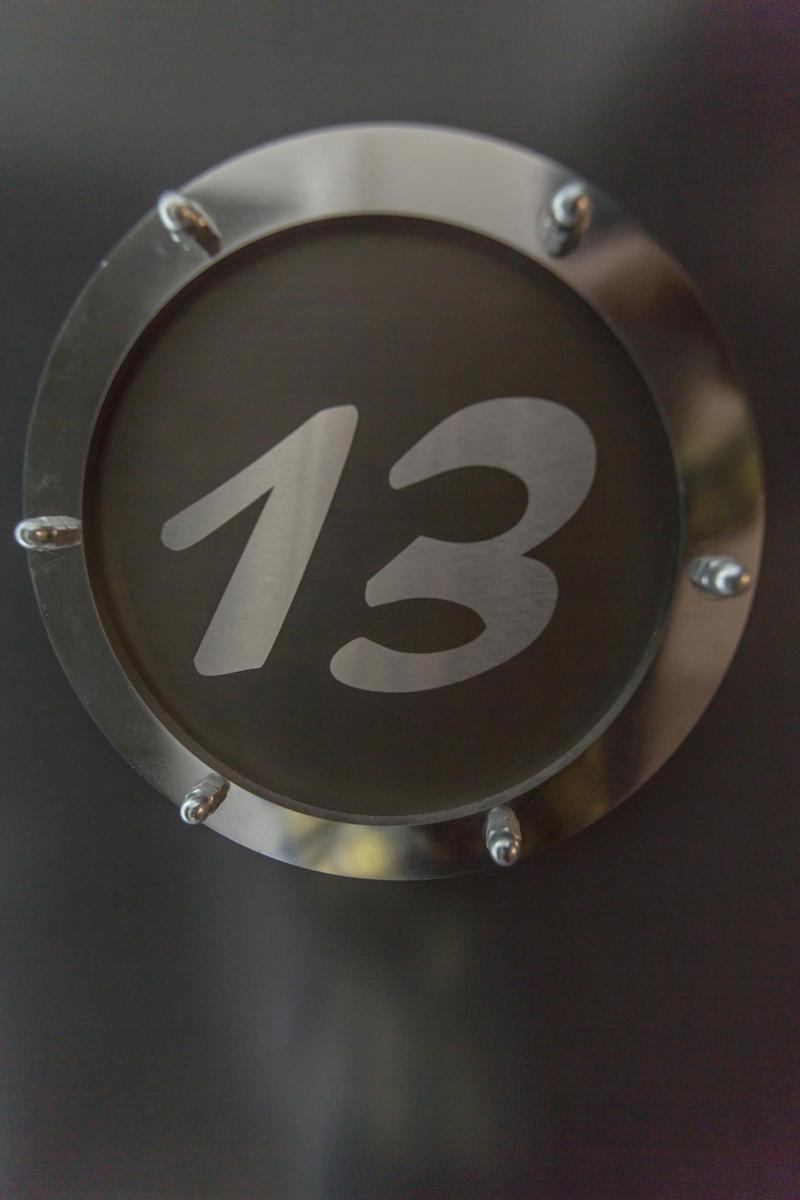 Wohnung 13 mit Küche, Bad, Schlafzimmer und Balkon. Flur und Wohnbereich sind eingezeichnet.