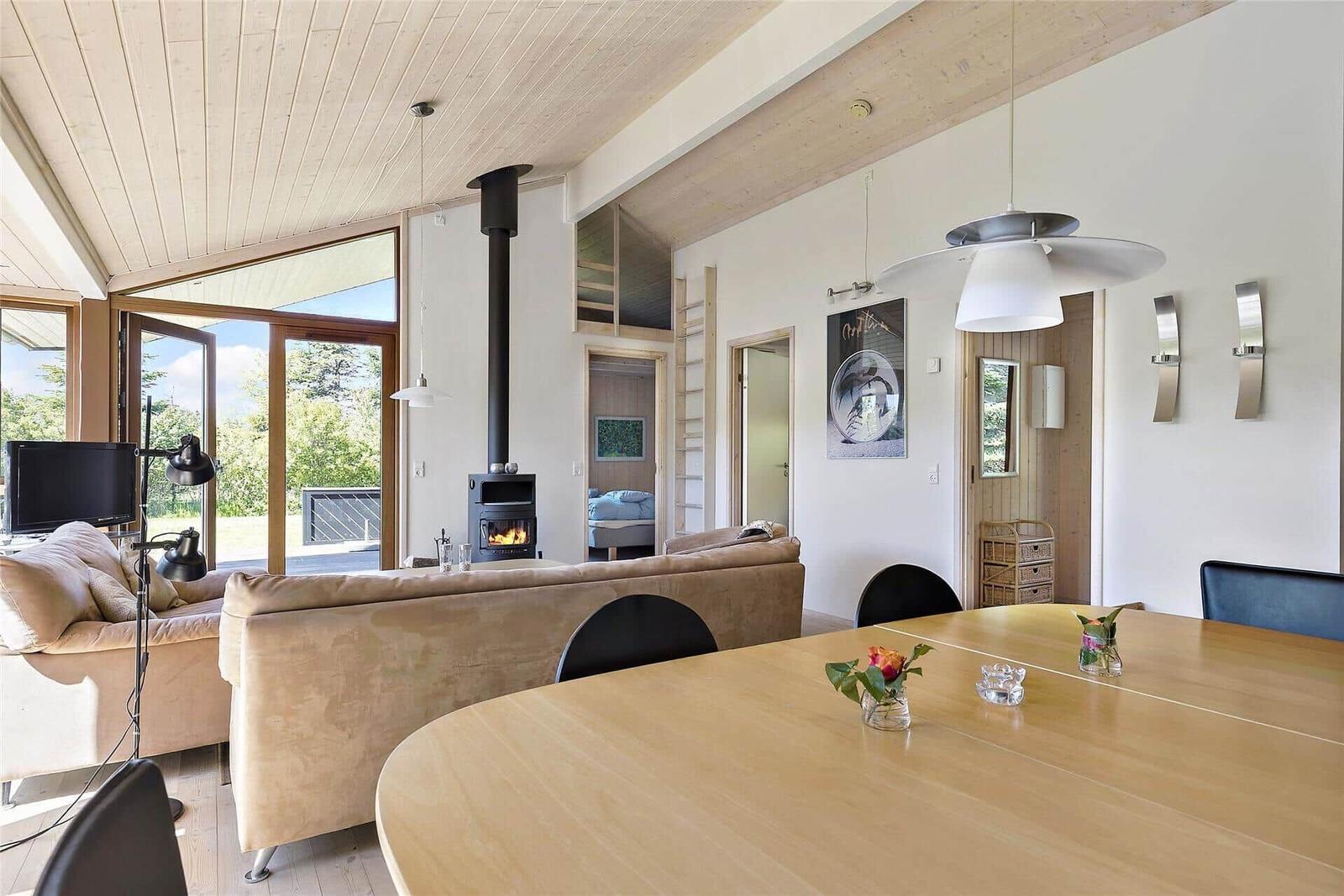 Moderne Villa mit Terrasse, Garten und Satellitenantenne. Holzterrasse mit Sitzgruppe.