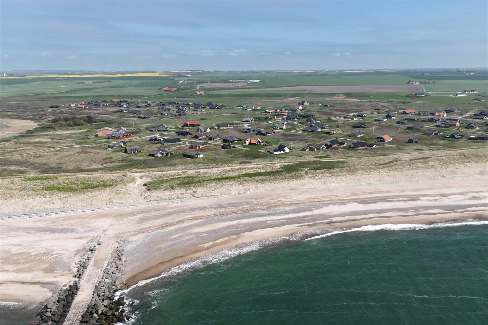 Aerial view of vacation homes near a large lake and coastal area.
