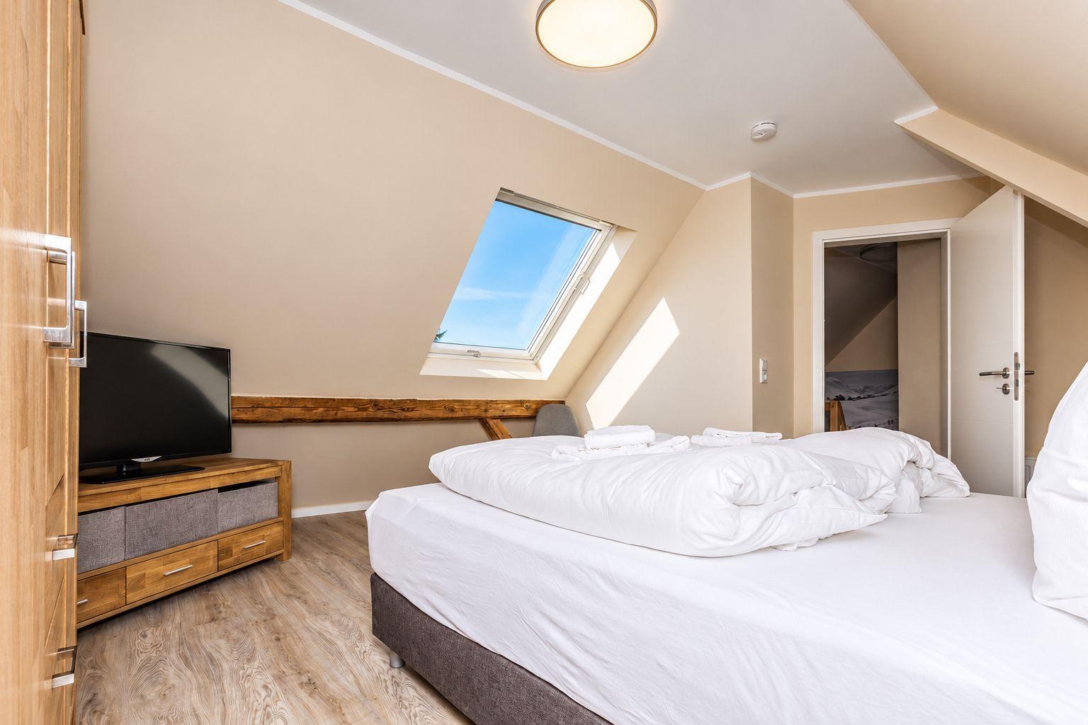 Apartment with sofa, kitchenette, and staircase to upper level.