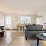 Living and dining area with fireplace, sofa, and table