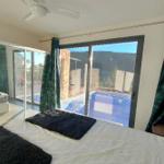 Schlafzimmer mit Blick auf Pool und Terrasse