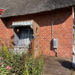 House with thatched roof and wicker sunshade