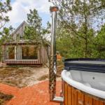 Hütte mit Whirlpool und Holzterrasse im Wald