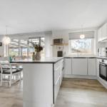 Modern kitchen with dining area and garden view