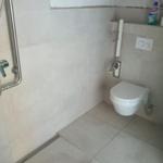 Badezimmer mit Dusche, WC und Handtuchhalter.