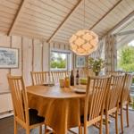 Esszimmer mit Holztisch, Stühlen und Fenster zur Terrasse