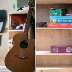 Akustische Gitarre und Brettspiele auf einem Holzregal.