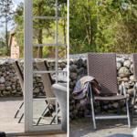 Terrasse mit Sitzgelegenheiten und Steinmauer im Hintergrund.