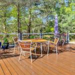 Terrasse mit Tisch, Stühlen und Sonnenschutz im Wald