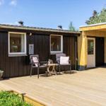 Holzterrasse mit Sitzgelegenheit und Blick auf das Haus