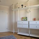 Schlafzimmer mit weißen Schränken und Spielzeug