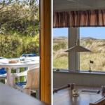 Terrasse mit Tisch und Stühlen. Blick auf Dünen und Himmel durch Fenster.