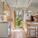 Küche mit Holzmöbeln und Blick auf einen Garten