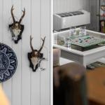 Wand mit Hirschgeweih und blauem Keramikplatten. Tisch mit Spiel und Gläsern.