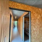 Flur mit Holzwänden und Schlafzimmer mit Doppelstockbett.