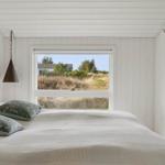 Bedroom with bed, window, and hook wall.