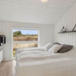 Bedroom with bed, window and white walls