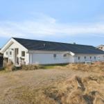 White house with black roof and garden