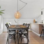 Dining area with wooden table, chairs, and kitchen counter